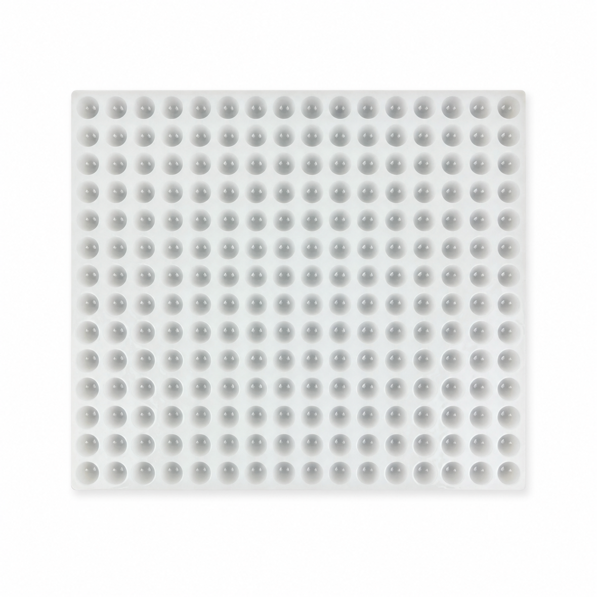 Commercial silicone gummy mold with 192 half-sphere cavities on a white background